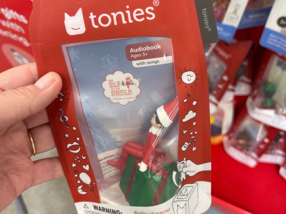 hand holding a package with an Elf on the Shelf Tonies figure