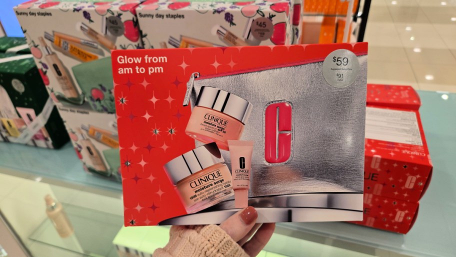 hand holding up a clinique gift set in a store