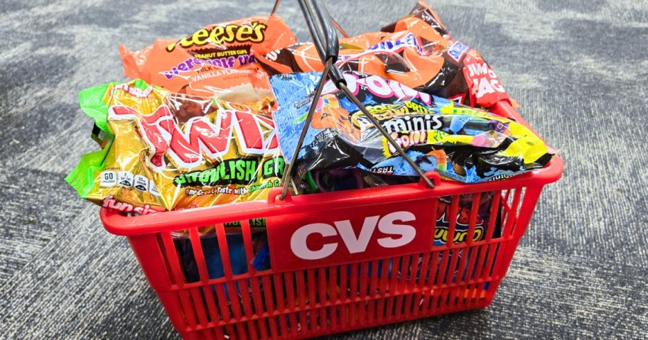 a CVS shopping basket with bags of Halloween candy in it