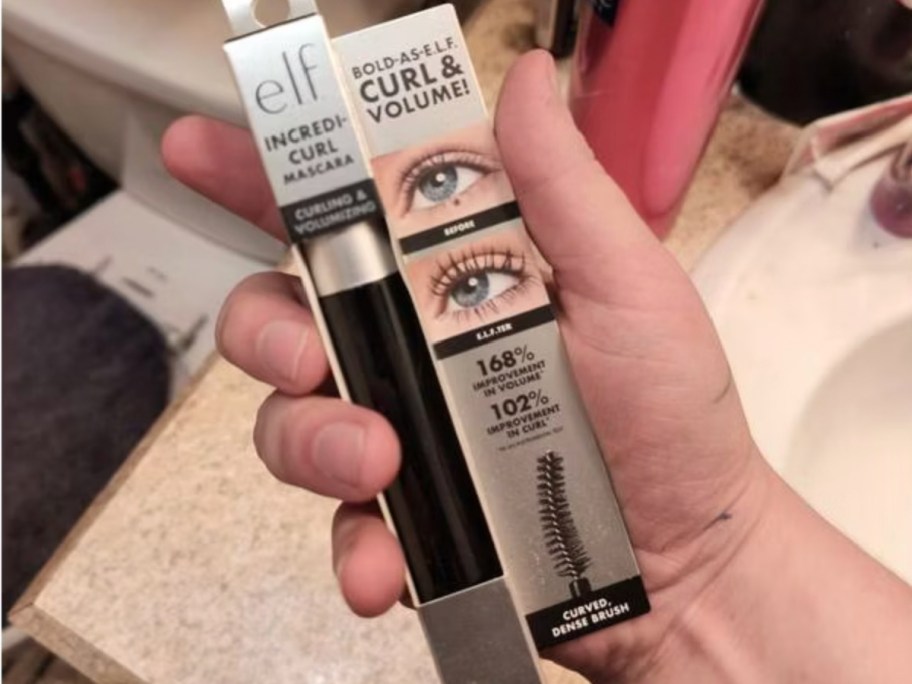 hand holding mascara in box