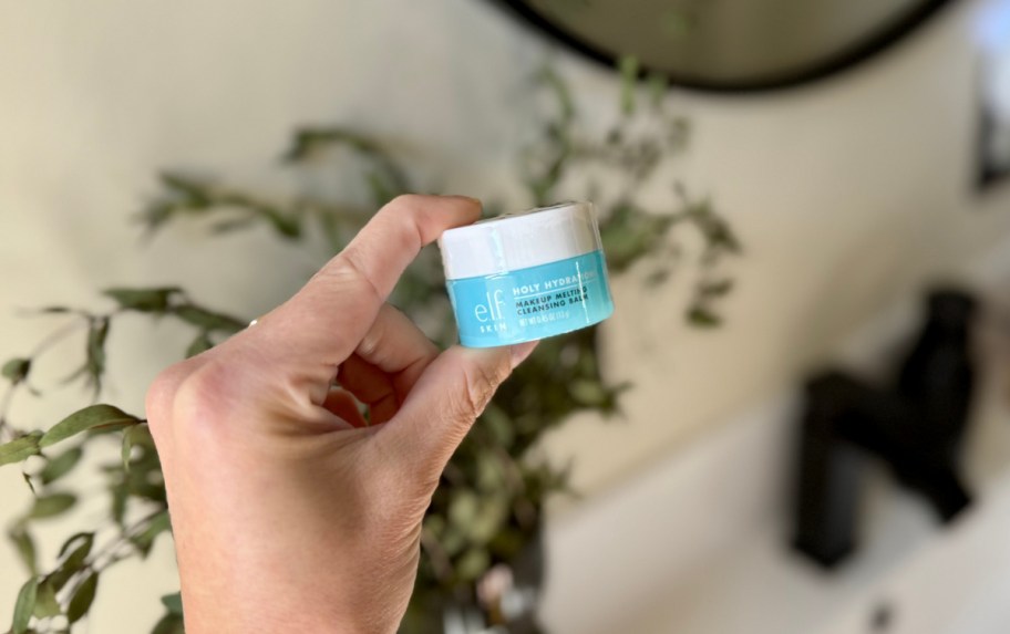 hand holding a jar of elf holy hydration