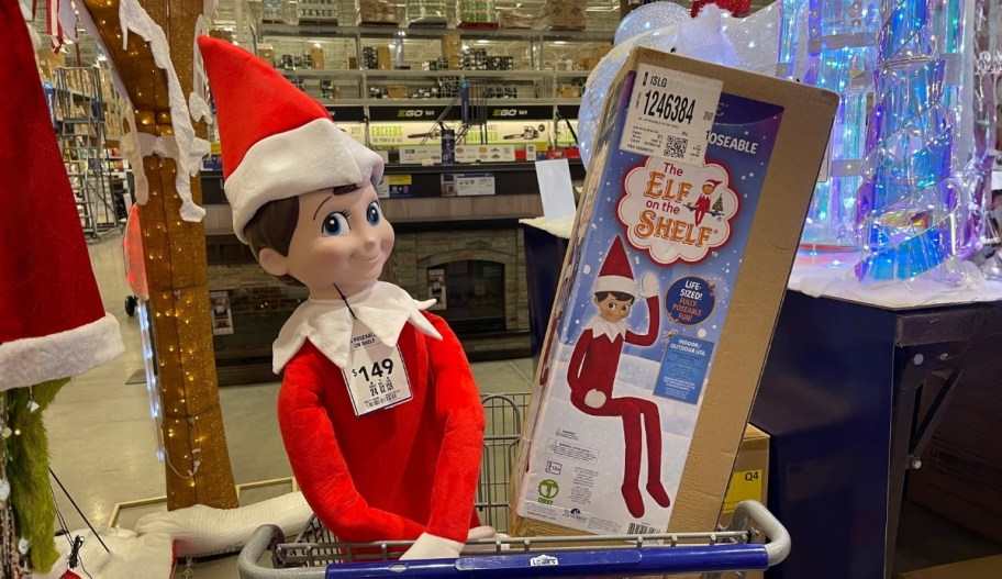 life size elf on the shelf in a lowes shopping cart