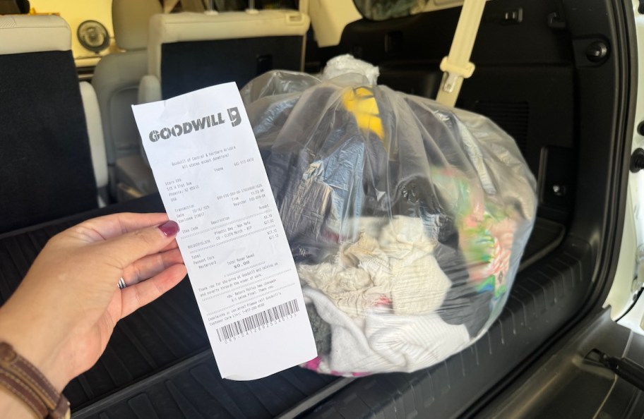 hand holding receipt from goodwill bins