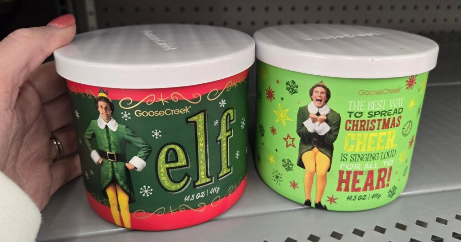 hand reaching for a Buddy the Elf candle on a store shelf