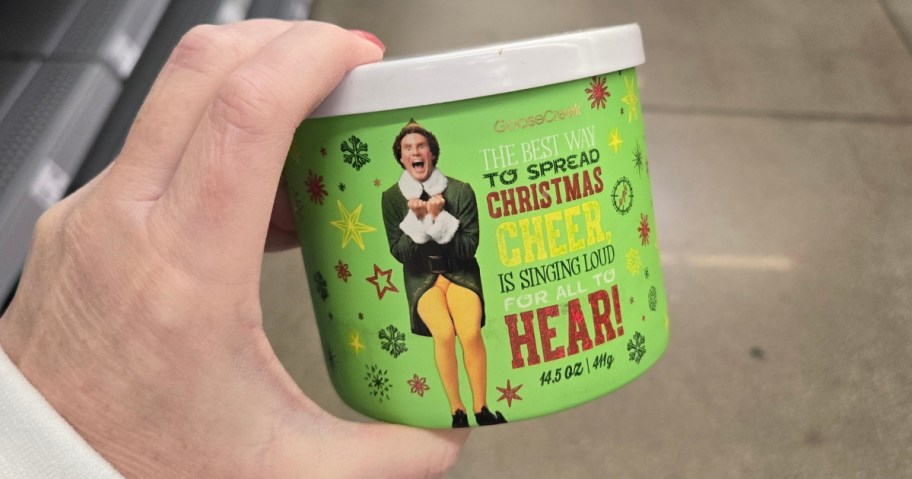 hand holding a Buddy the Elf inspired Goose Creek holiday candle