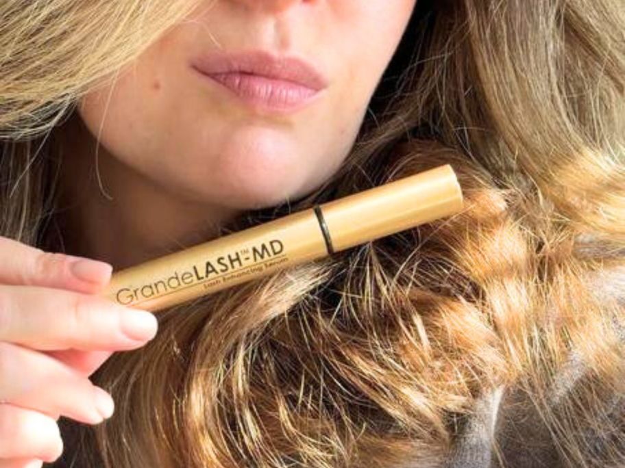 woman holding up Grande Lash MD
