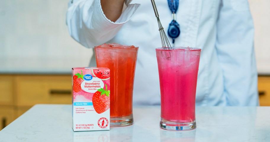 adding great value drink mix to water on a kitchen counter