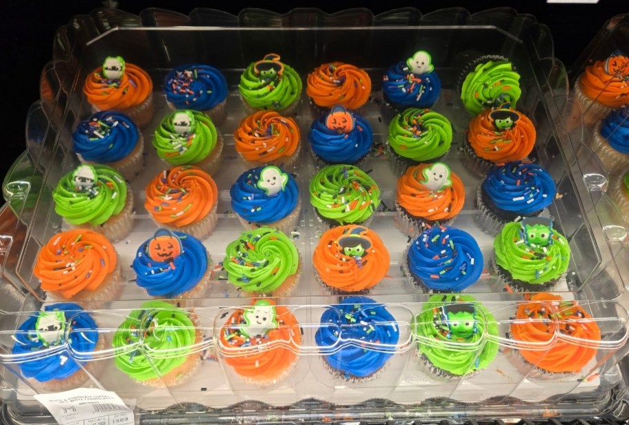 24 cup cakes frosted and decorated for halloween 