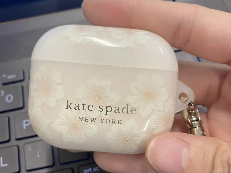 holding a floral AirPods case