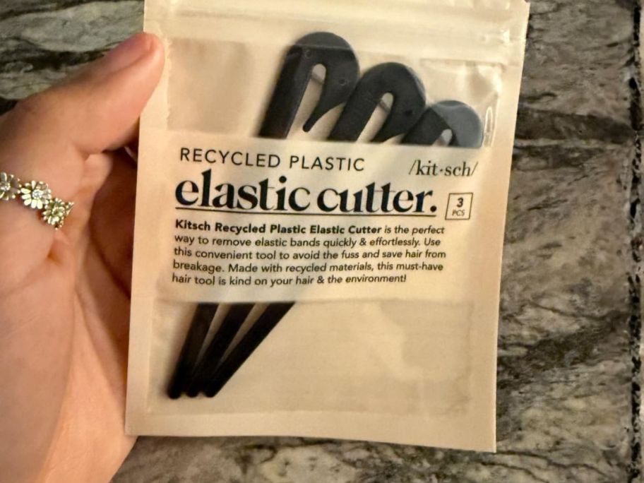 hand holding Kitsch Hair Tie Cutters in package
