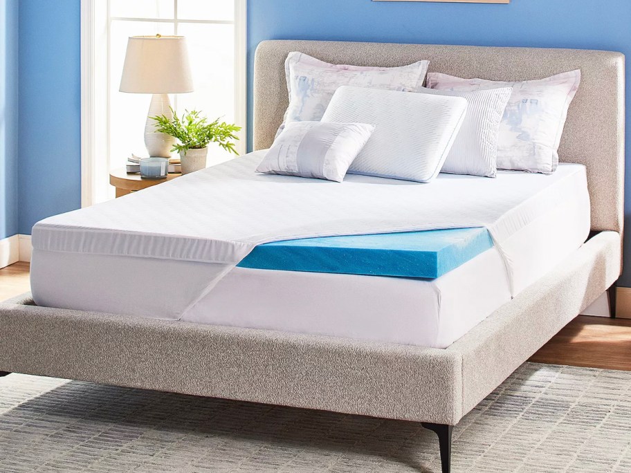 white and blue serta mattress on bed with pillows 