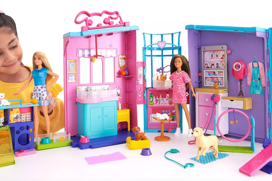 girl playing with barbie vet playset
