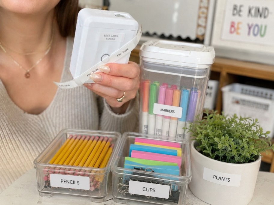 hand holding label maker on school supplies