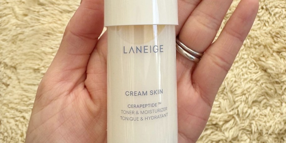 hand holding laneige cream skin toner bottle