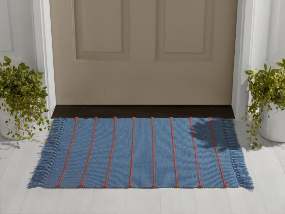 blue striped Mainstays by Becky G. & Alejandra Layering Rug in front of door