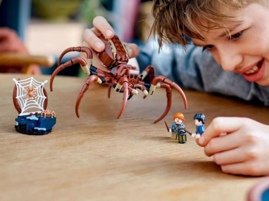 kid playing with LEGO Harry Potter Aragog in the Forbidden Forest