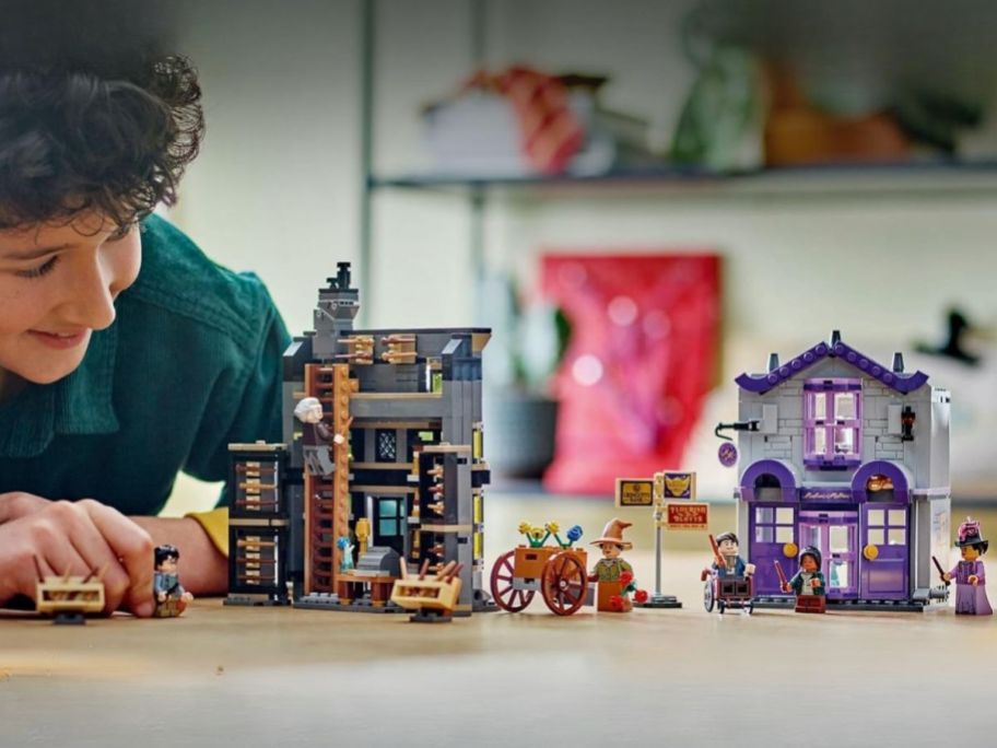 kid playing with LEGO Harry Potter Ollivanders & Madam Malkin's Robes