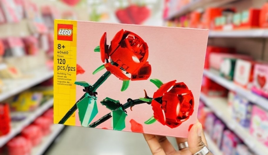 womans hand holding a box of LEGO roses