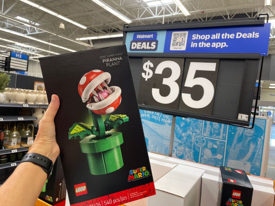 hand holding LEGO Super Mario Piranha Plant up to price sign