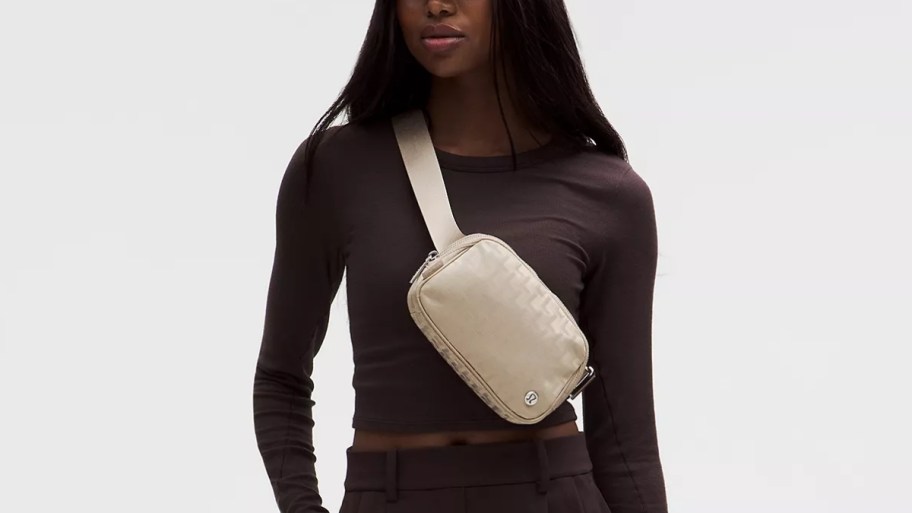 woman with a beige belt bag