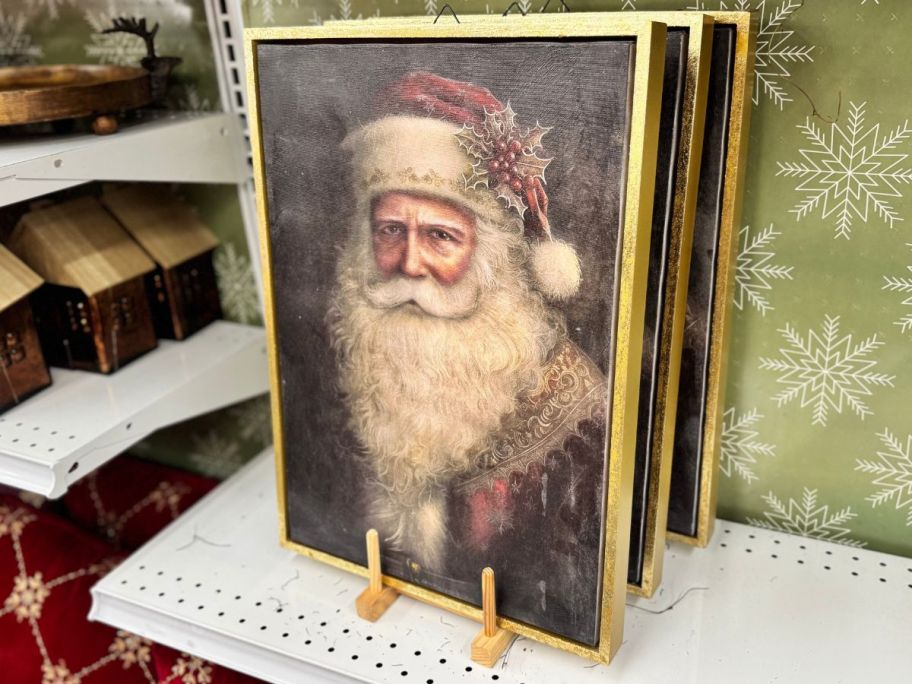 Snowy Santa & Sleigh Wall Décor on shelf in store