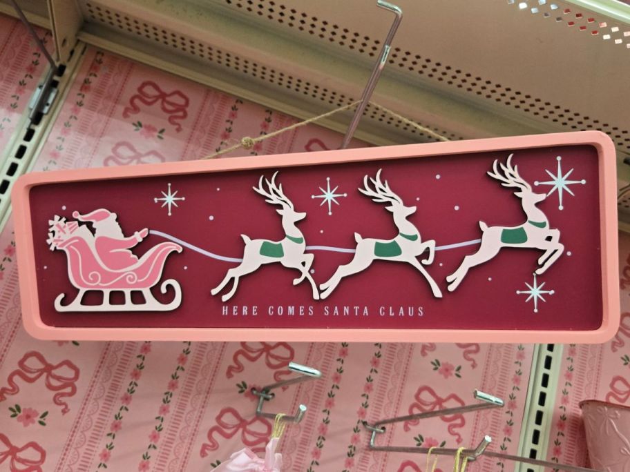 Here Comes Santa Claus Wall Sign hanging in store