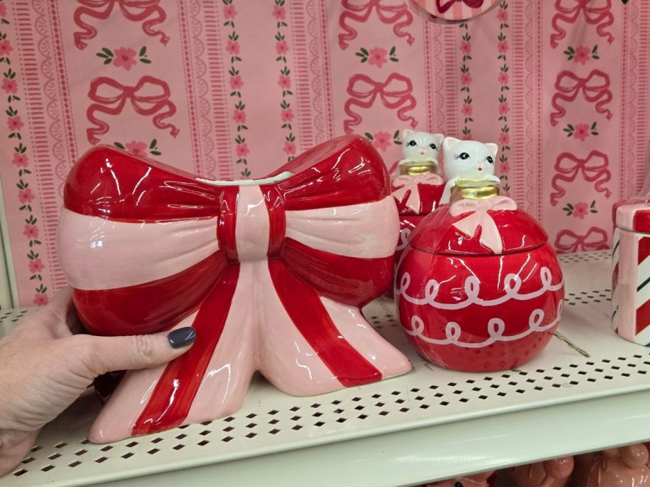 Pink Stripe Bow and ornament containers on shelf in store