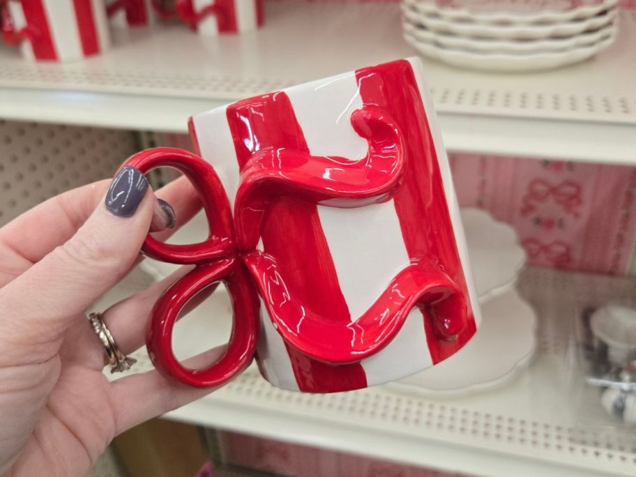 Red & White Stripes w/ Bow Mug in hand in store