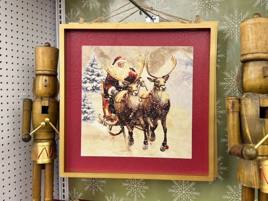 Snowy Santa & Sleigh Wall Décor hanging in store