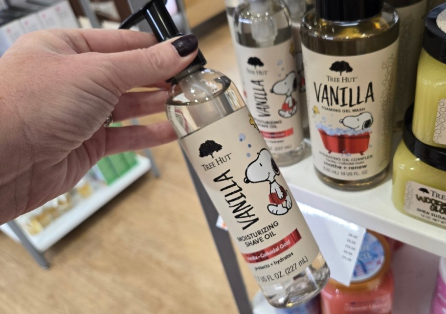 womans hand holding a bottle of vanilla shave oil