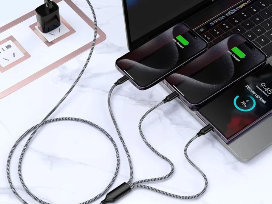 multi charging cable hooked up to phones and laptop
