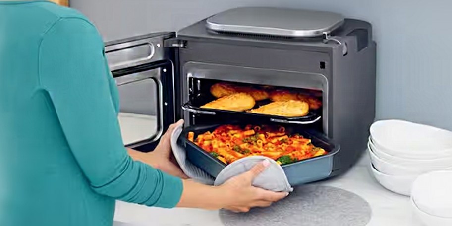 woman putting food in ninja multicooker
