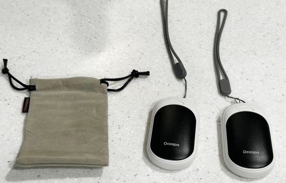 white and black hand warmers with bag 