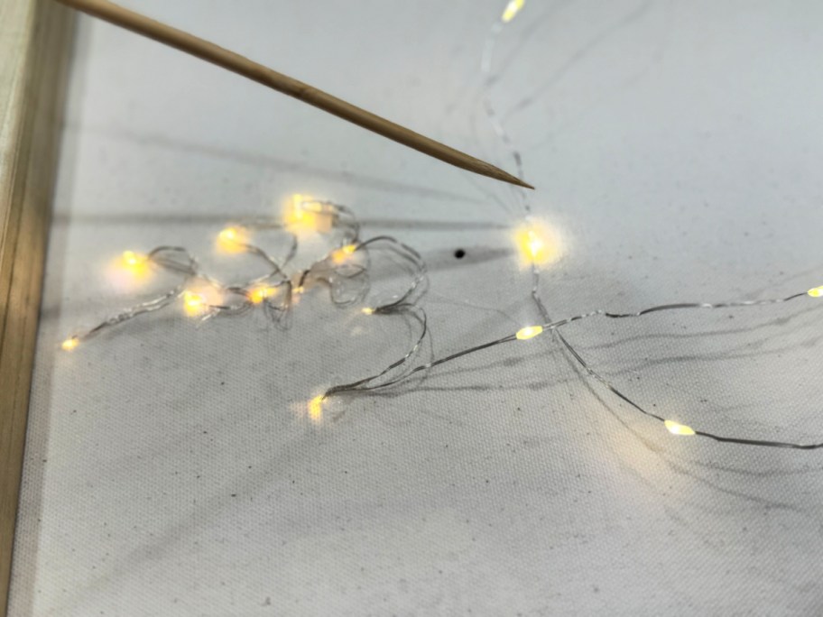 poking holes in the back of a photo canvas