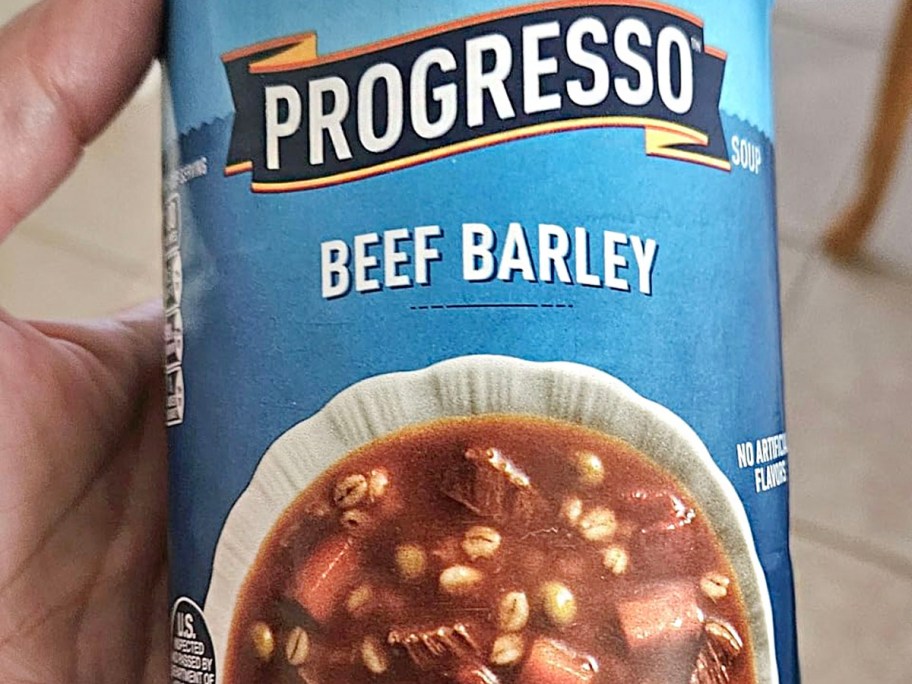 hand holding progresso beef barley can