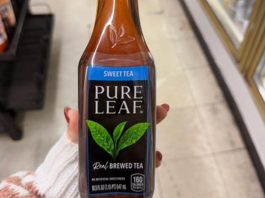 holding a bottle of sweet tea