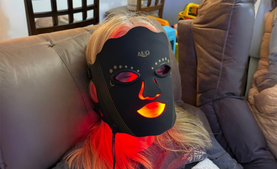 woman wearing a red light therapy mask