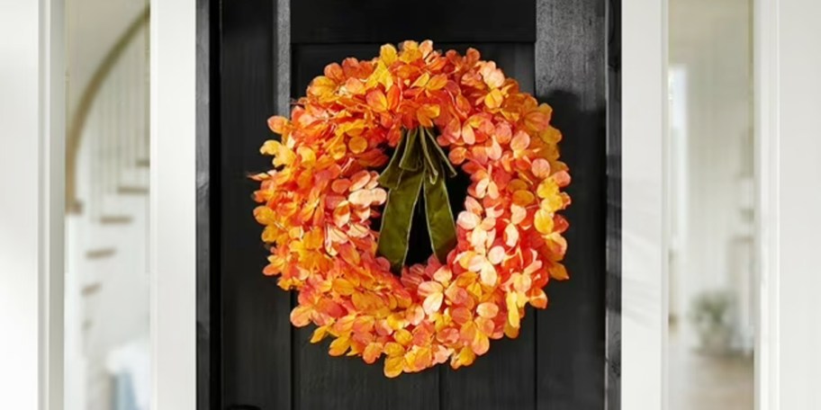 orange leaf wreath on black door