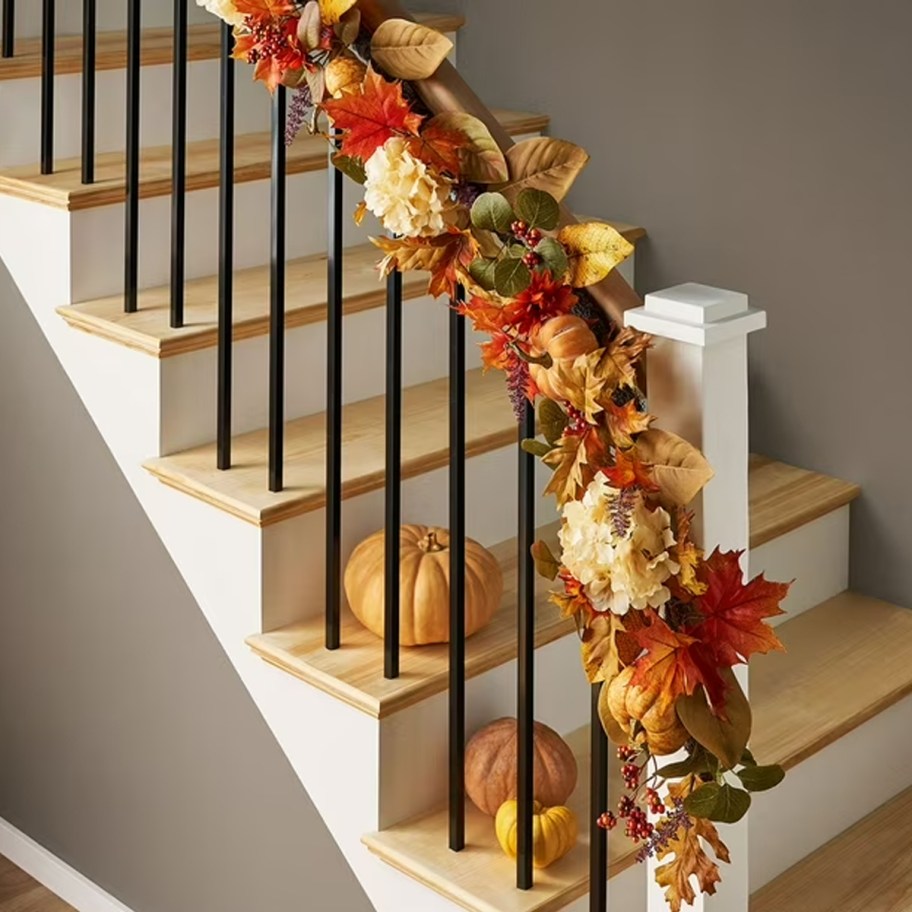 orange, white and red leaf garland on stairs