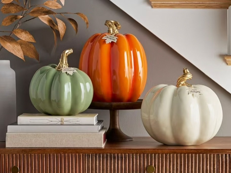 green, orange, and white pumpkins on table