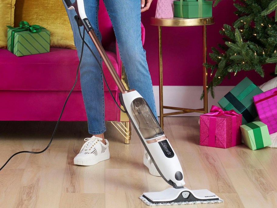 woman using white steammop 