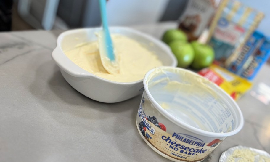 spreading cheesecake filling in a dish