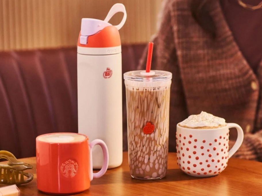 various fall-themed Starbucks tumblers and mugs