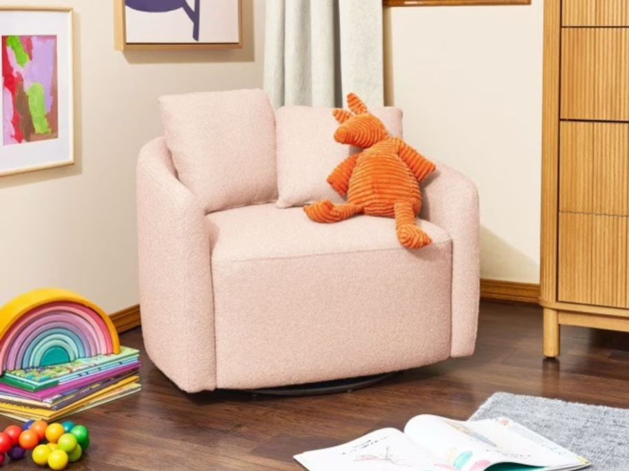 pink kids swivel chair with stuffed animal on it in kids room