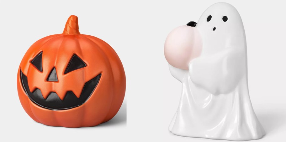 orange pumpkin and white ghost holding pink pumpkin 