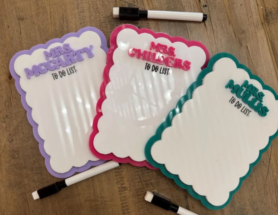 personalized whiteboards with purple pink and green names