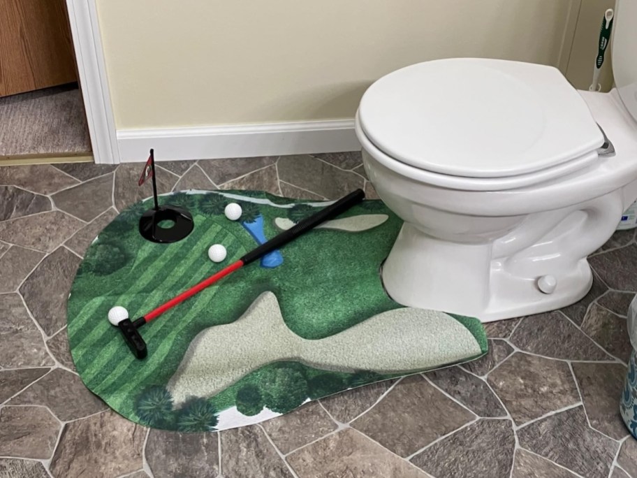 toilet golf game around white toilet in bathroom
