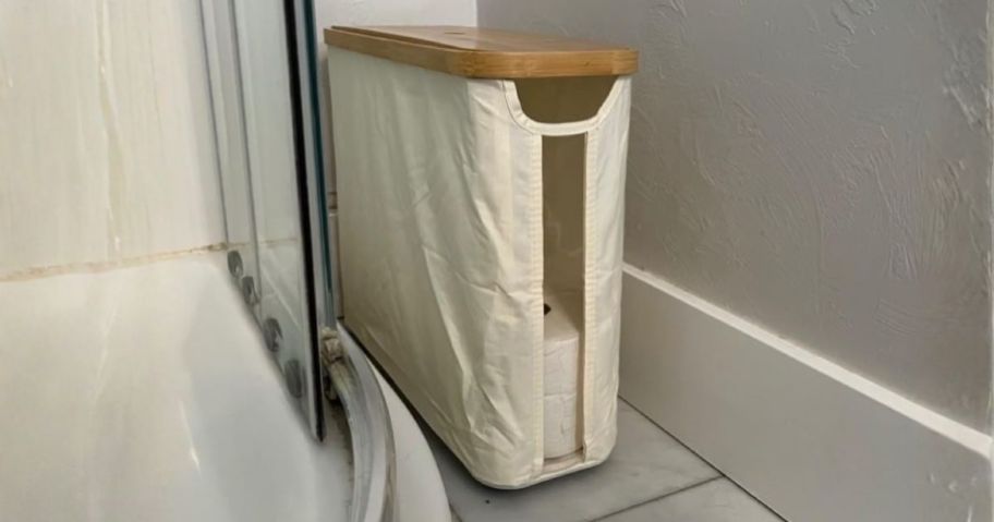 toilet paper storage basket next to shower
