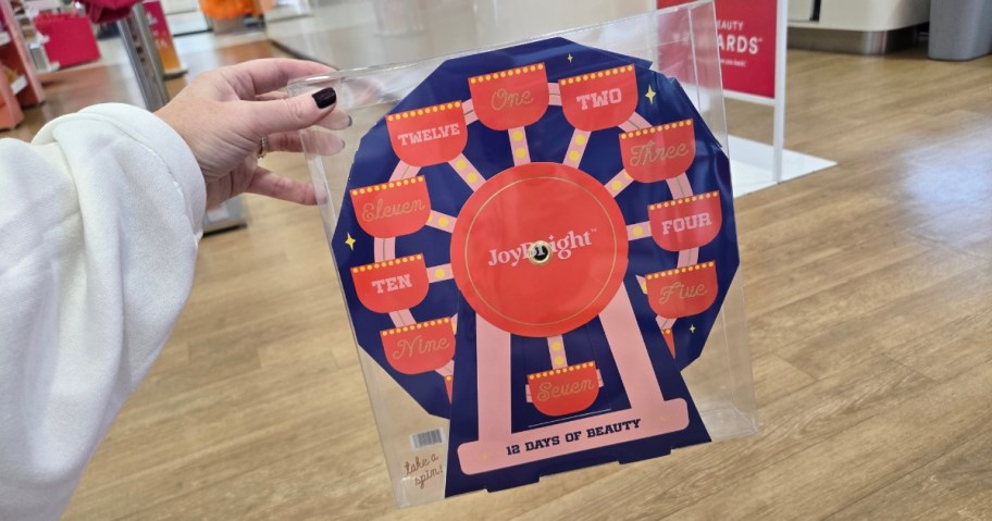 hand holding a beauty advent calendar that looks like a ferris wheel