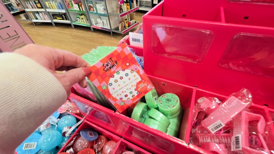display of ulta beauty stocking stuffers with a hand pulling an item out